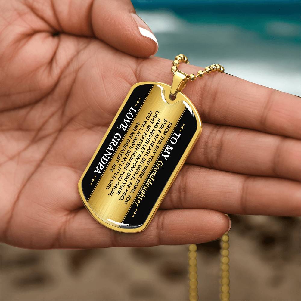 To My Granddaughter Necklace from Grandpa – gold dog tag held in hand to show size