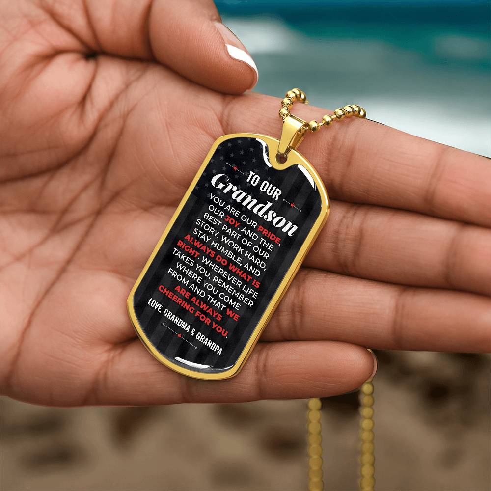 To Our Grandson Necklace from Grandma & Grandpa – gold dog tag held in hand to show size