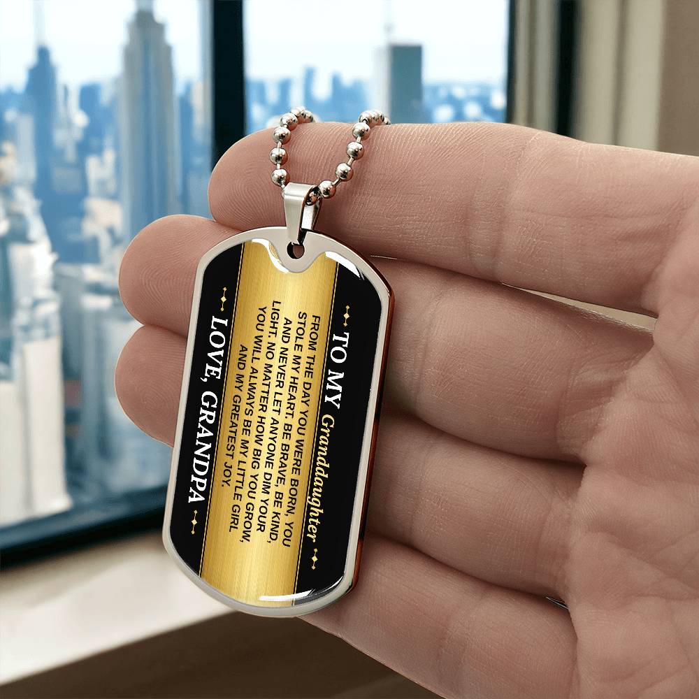To My Granddaughter Necklace from Grandpa – silver dog tag held in hand to show size