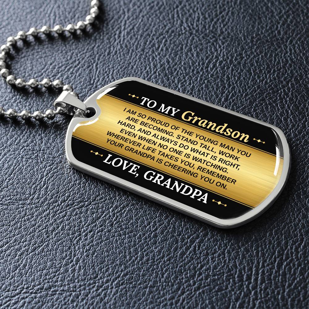To My Grandson Necklace from Grandpa – dog tag necklace laid flat on a dark background
