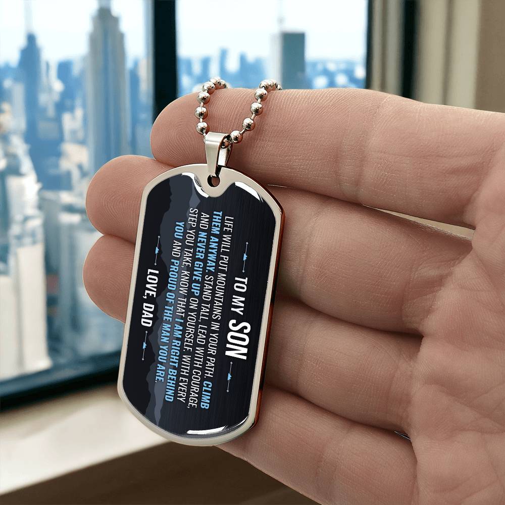 To My Son Necklace from Dad – silver dog tag held in hand to show size