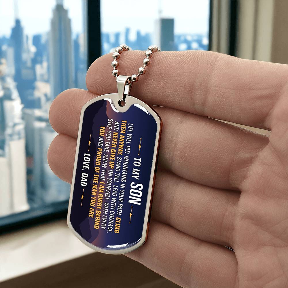 To My Son Necklace from Dad – silver dog tag held in hand to show size