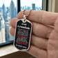 To Our Grandson Necklace from Grandma & Grandpa – silver dog tag held in hand to show size