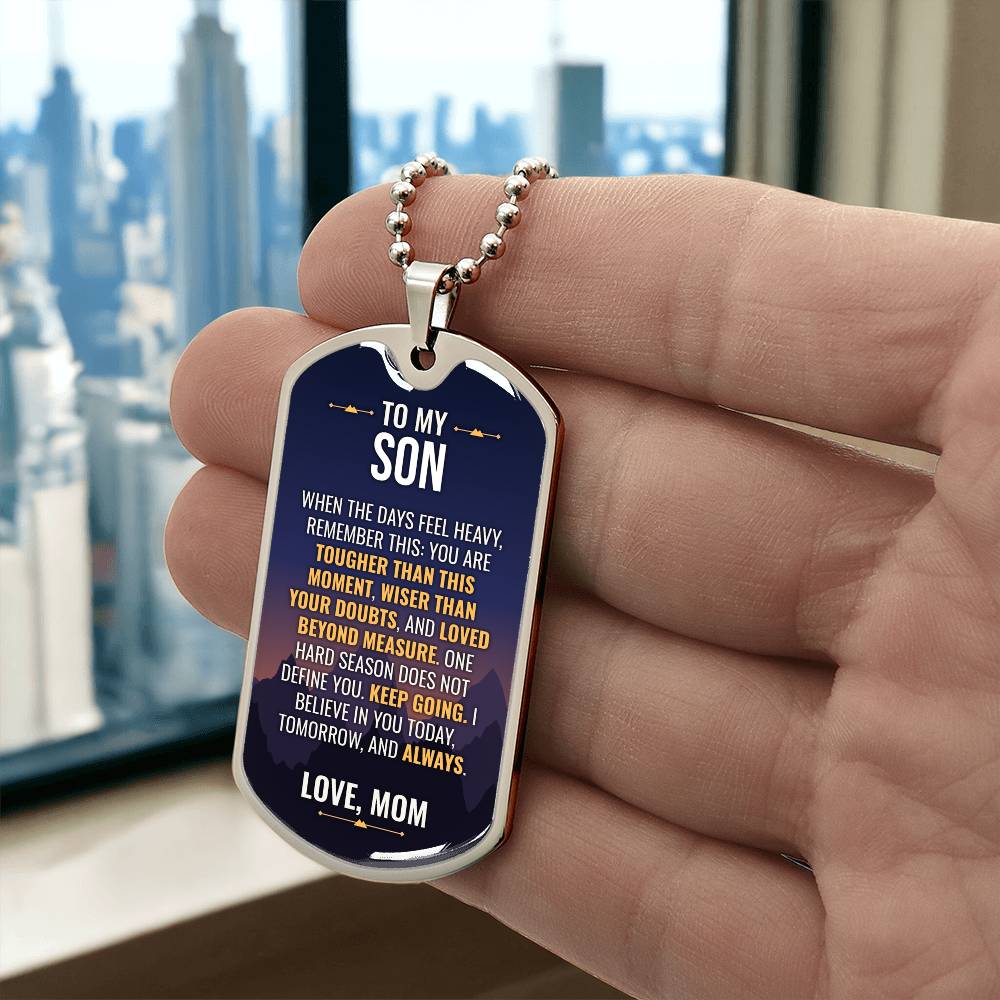 To My Son Necklace from Mom – silver dog tag held in hand to show size