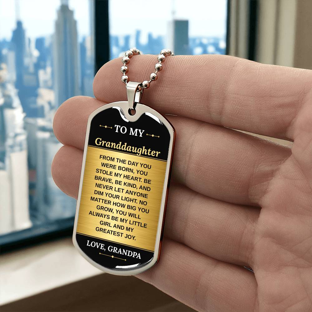 To My Granddaughter Necklace from Grandpa – silver dog tag held in hand to show size