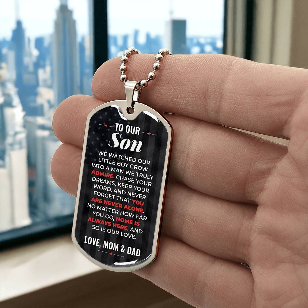 To Our Son Necklace from Mom & Dad – silver dog tag held in hand to show size
