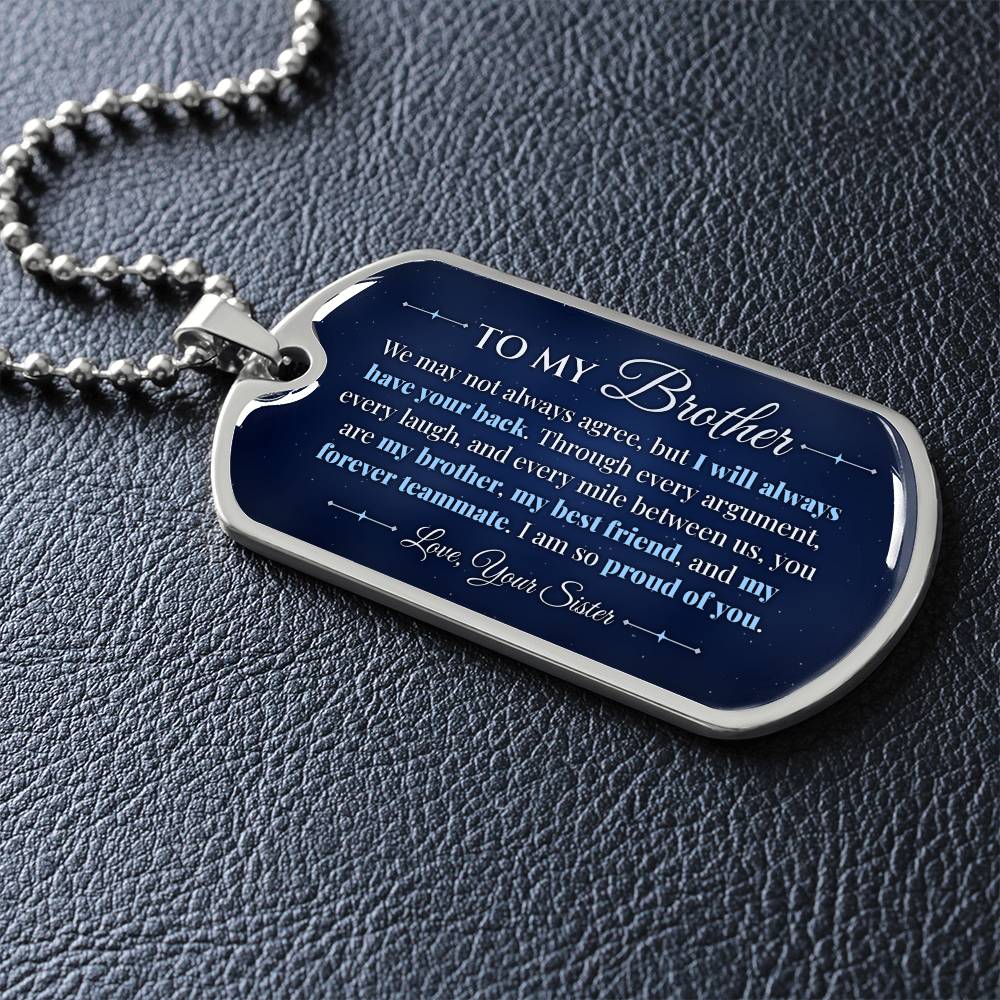 To My Brother Necklace from Sister – silver dog tag necklace lying flat on black leather so the sideways message reads clearly