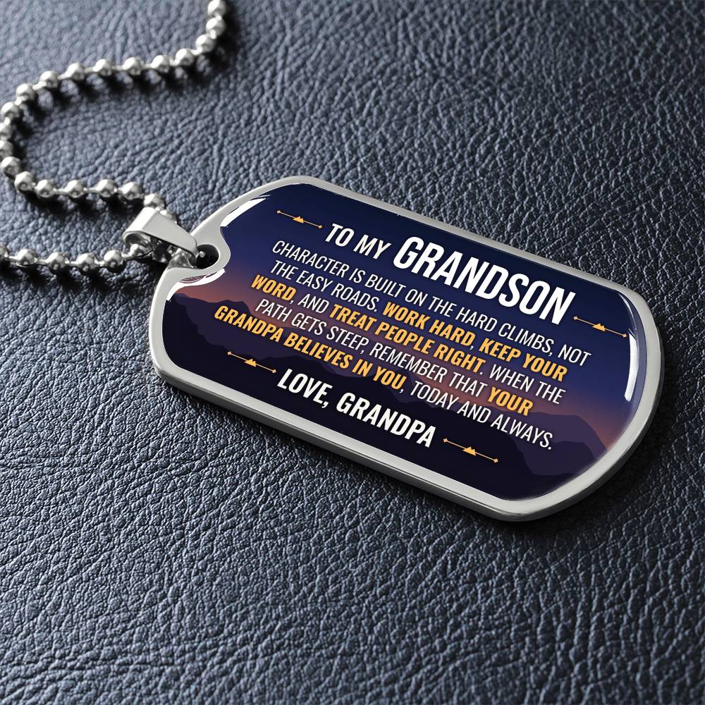 To My Grandson Necklace from Grandpa – silver dog tag necklace lying flat on black leather so the sideways message reads clearly