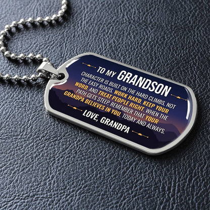To My Grandson Necklace from Grandpa – silver dog tag necklace lying flat on black leather so the sideways message reads clearly