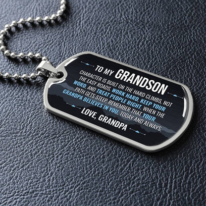 To My Grandson Necklace from Grandpa – silver dog tag necklace lying flat on black leather so the sideways message reads clearly