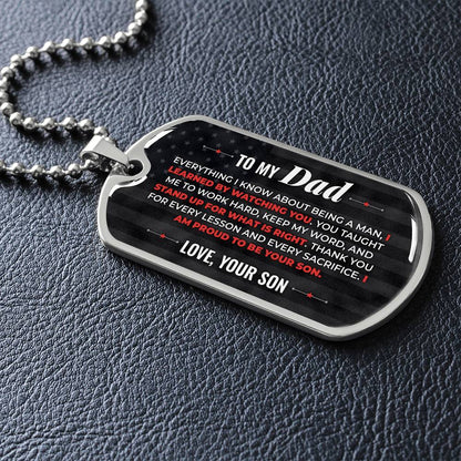 To My Dad Necklace from Son – silver dog tag necklace lying flat on black leather so the sideways message reads clearly