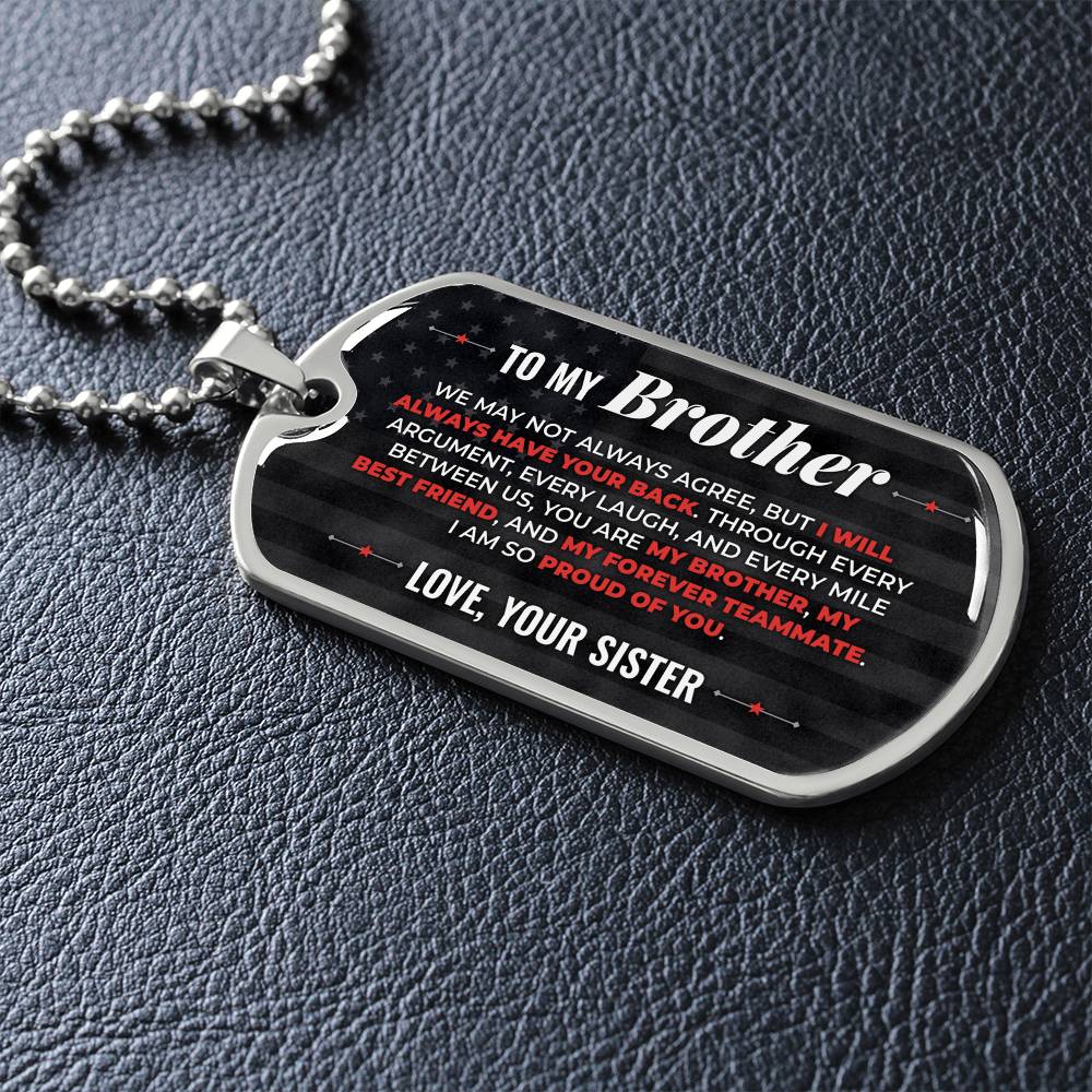 To My Brother Necklace from Sister – silver dog tag necklace lying flat on black leather so the sideways message reads clearly