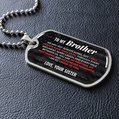 To My Brother Necklace from Sister – silver dog tag necklace lying flat on black leather so the sideways message reads clearly