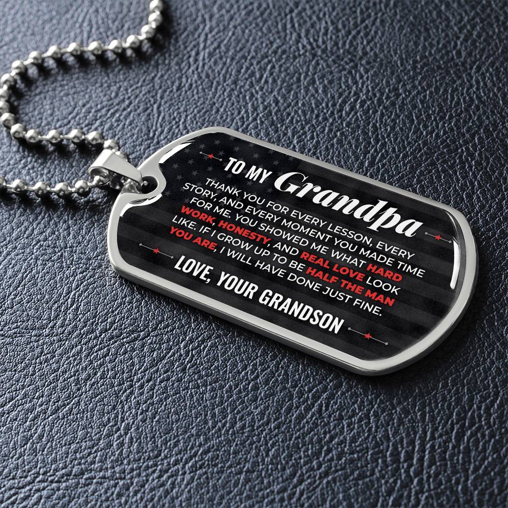 To My Grandpa Necklace from Grandson – silver dog tag necklace lying flat on black leather so the sideways message reads clearly