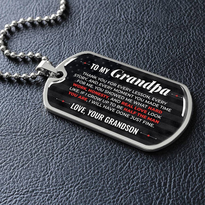 To My Grandpa Necklace from Grandson – silver dog tag necklace lying flat on black leather so the sideways message reads clearly