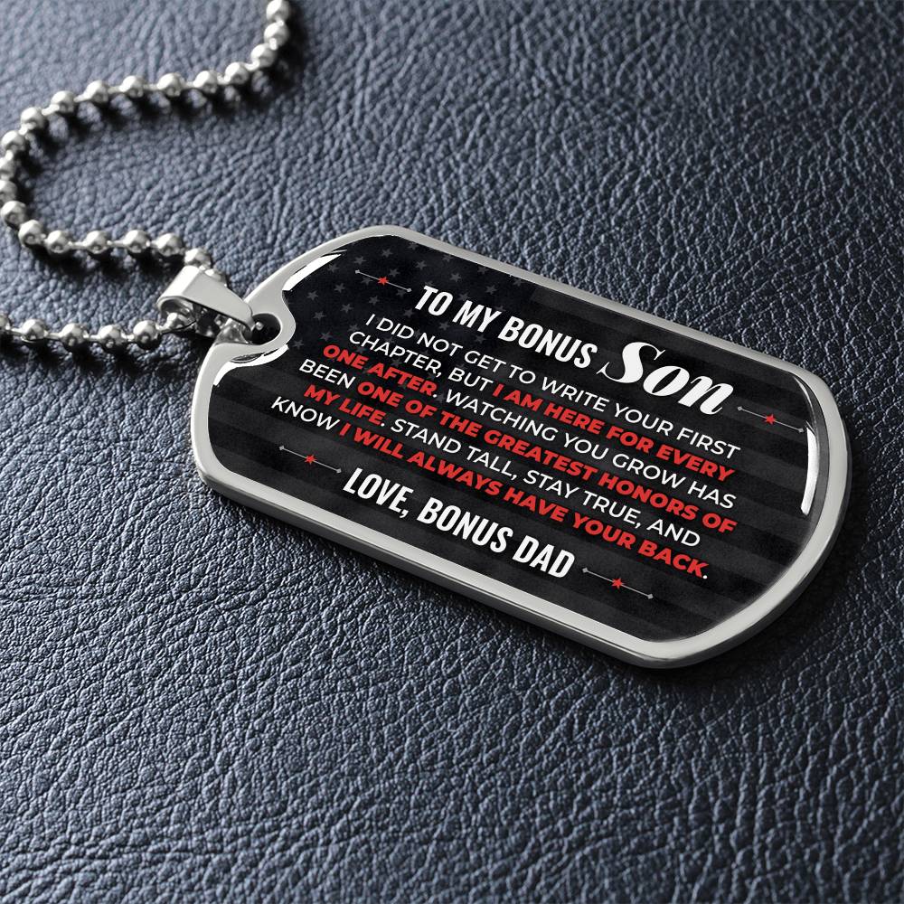 To My Bonus Son Necklace from Stepdad – silver dog tag necklace lying flat on black leather so the sideways message reads clearly