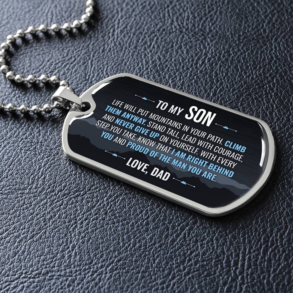 To My Son Necklace from Dad – silver dog tag necklace lying flat on black leather so the sideways message reads clearly