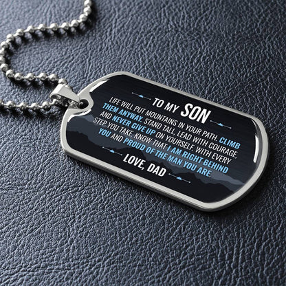 To My Son Necklace from Dad – silver dog tag necklace lying flat on black leather so the sideways message reads clearly