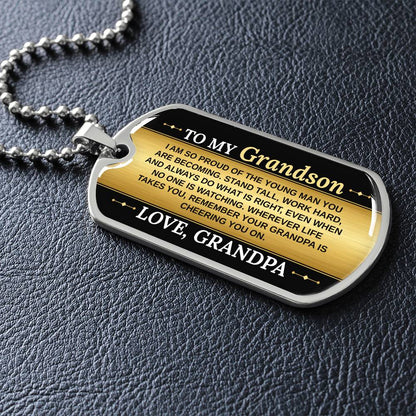 To My Grandson Necklace from Grandpa – silver dog tag necklace lying flat on black leather so the sideways message reads clearly
