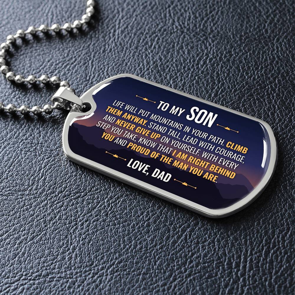 To My Son Necklace from Dad – silver dog tag necklace lying flat on black leather so the sideways message reads clearly