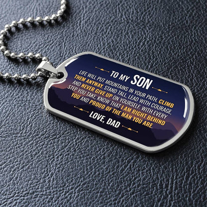 To My Son Necklace from Dad – silver dog tag necklace lying flat on black leather so the sideways message reads clearly