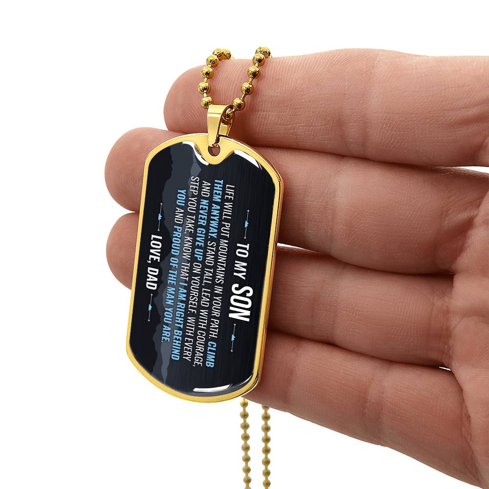 To My Son Necklace from Dad – gold dog tag held in hand to show size