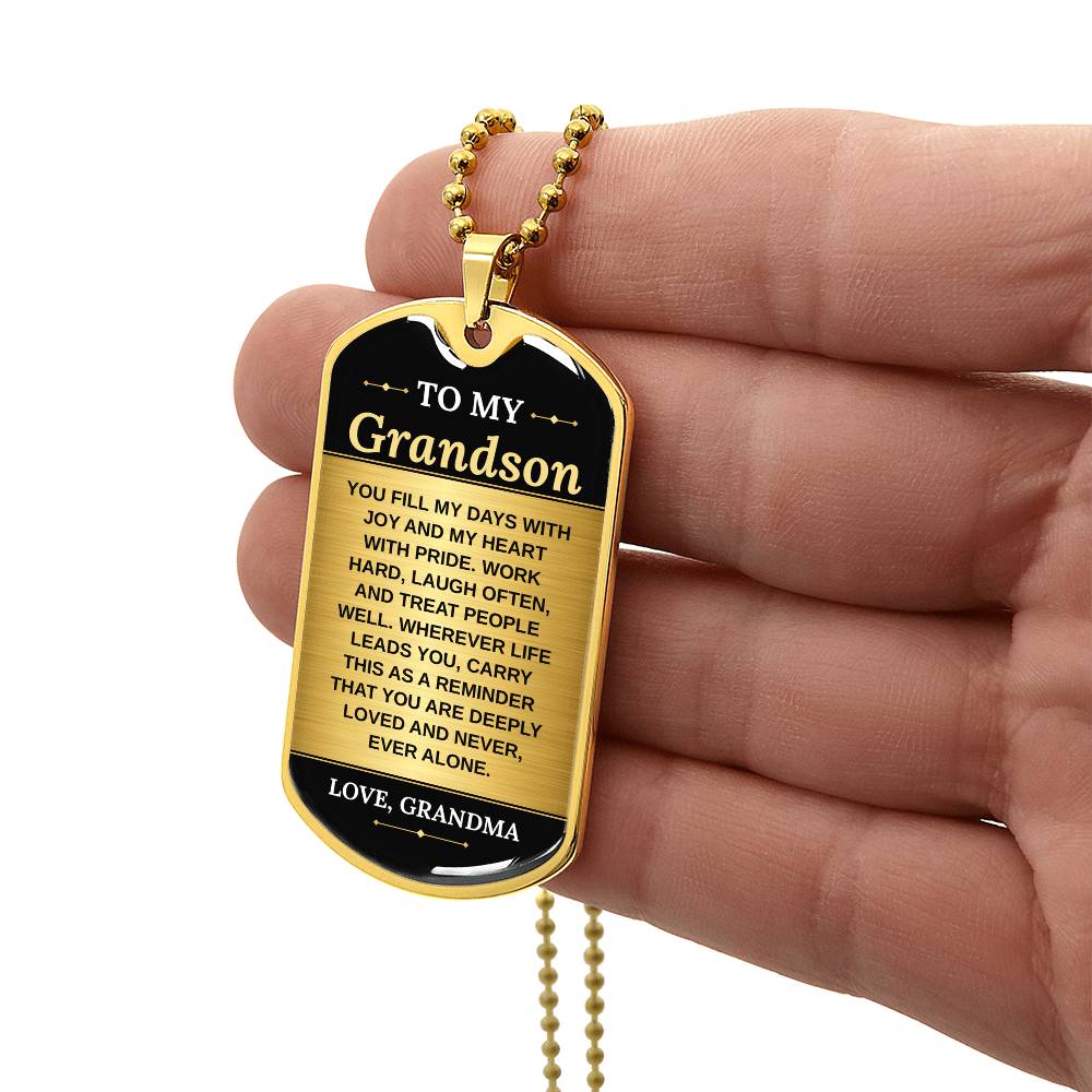 To My Grandson Necklace from Grandma – gold dog tag held in hand to show size