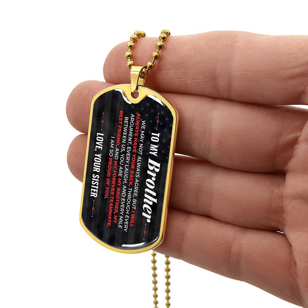 To My Brother Necklace from Sister – gold dog tag held in hand to show size