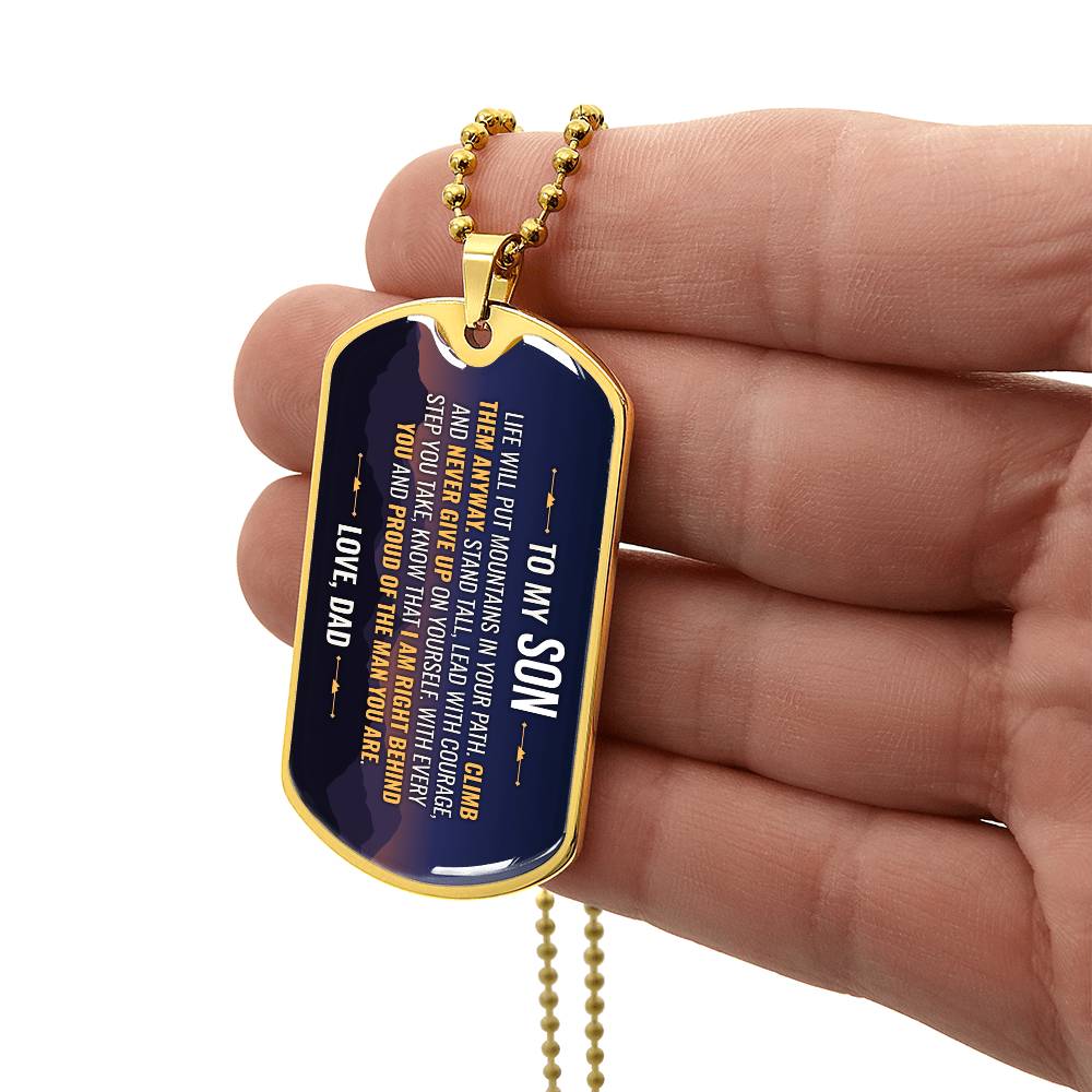 To My Son Necklace from Dad – gold dog tag held in hand to show size