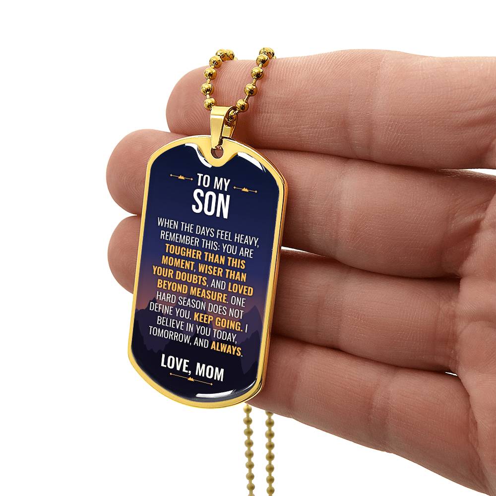 To My Son Necklace from Mom – gold dog tag held in hand to show size