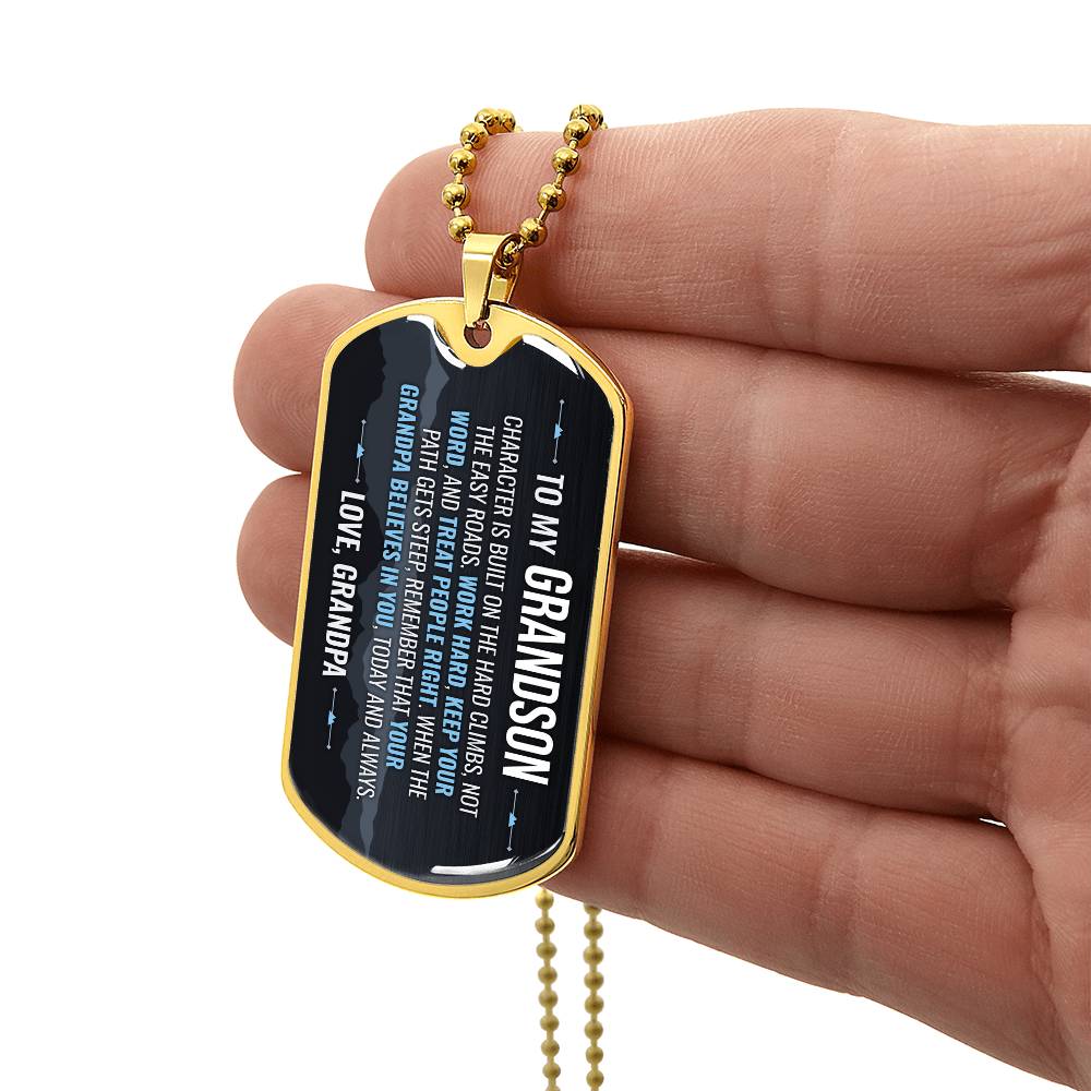 To My Grandson Necklace from Grandpa – gold dog tag held in hand to show size