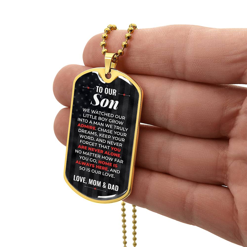 To Our Son Necklace from Mom & Dad – gold dog tag held in hand to show size