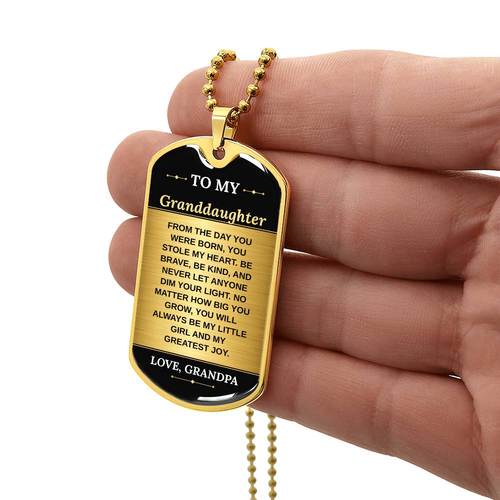 To My Granddaughter Necklace from Grandpa – gold dog tag held in hand to show size