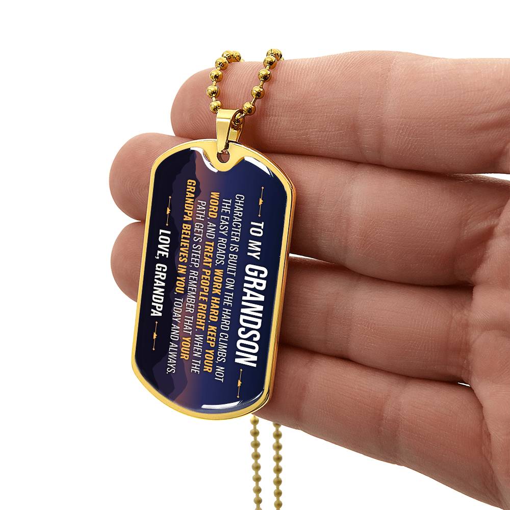 To My Grandson Necklace from Grandpa – gold dog tag held in hand to show size