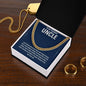 Gold uncle necklace with message card on a wooden table