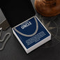 Stainless steel uncle necklace in open gift box on a dark tabletop