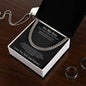 Black To My Son message card and Cuban link chain in gift box on dark wood table beside steel rings and dog tag