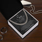 Cuban link chain gift for son from Mom on charcoal card in open box, wood table, silver dog tag and dark rings