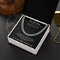 Silver Cuban link chain on black To My Son card in gift box on dark surface beside a gold dog tag chain