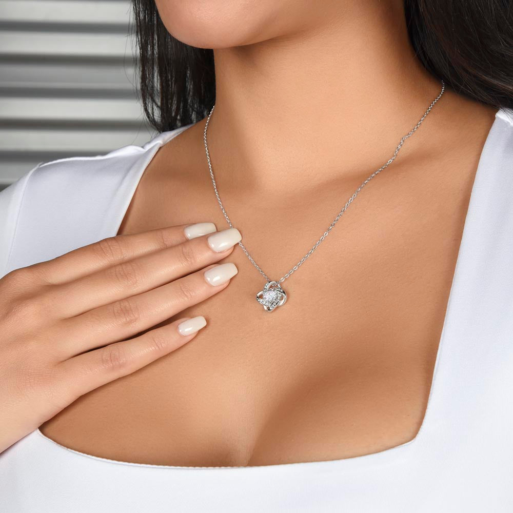 Love Knot pendant worn with a white top