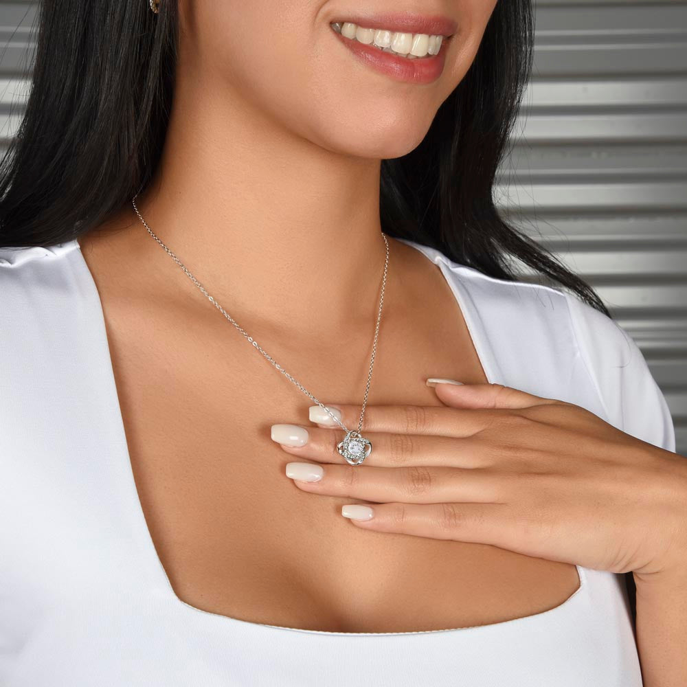Smiling woman wearing the Love Knot necklace