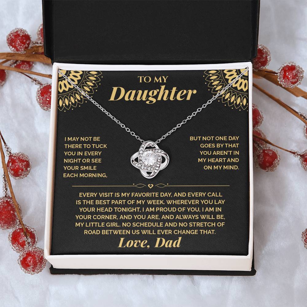Black and gold To My Daughter card from Dad and Love Knot necklace in a white gift box with red berries