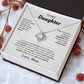 Tilted white gift box holding the white To My Daughter card from Mom and Love Knot necklace among red berries