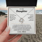 Hand holding the white To My Daughter card from Mom and Love Knot necklace gift box on a beach