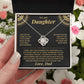 Hand holding the black and gold To My Daughter card from Dad gift box among pink and white flowers