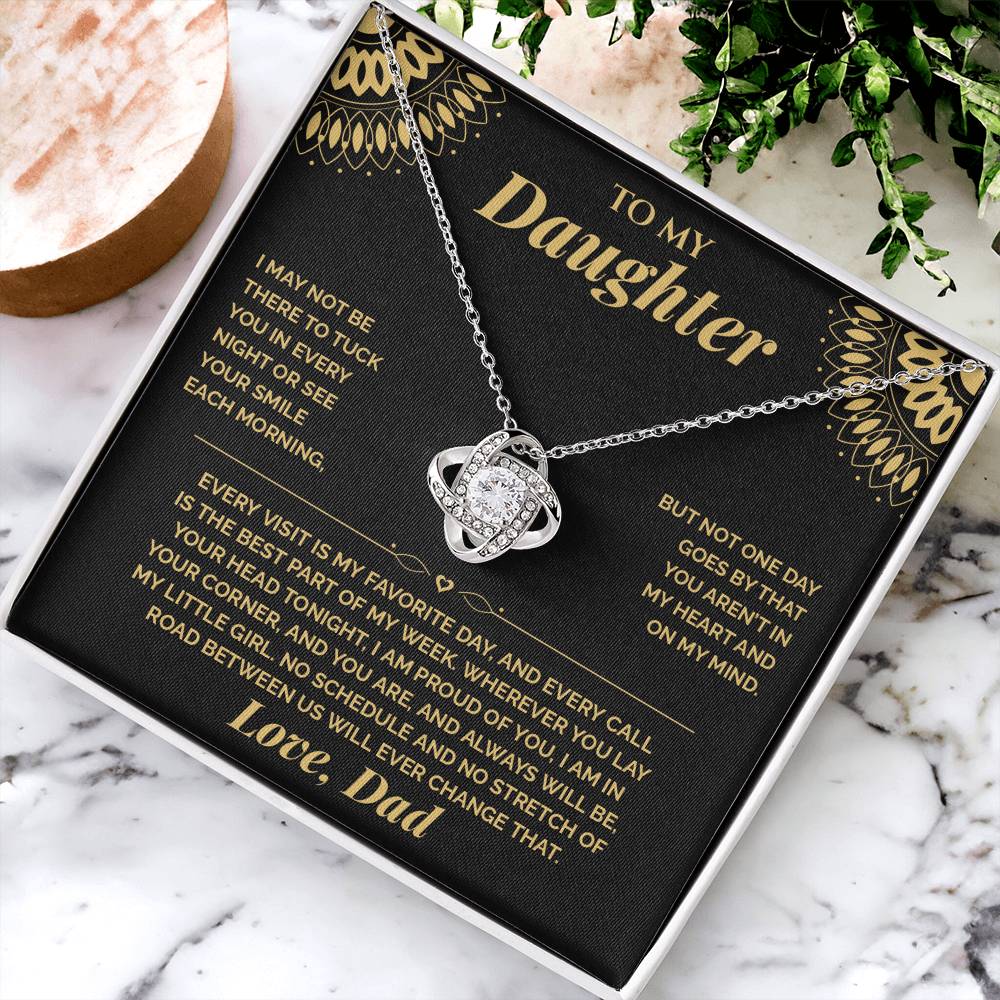 Open black gift box with the black and gold To My Daughter card from Dad and Love Knot necklace, angled view