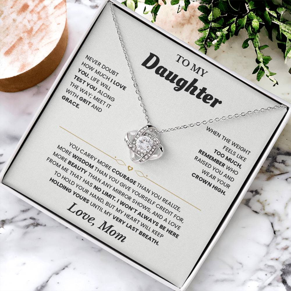 Open black gift box with the white To My Daughter card from Mom and Love Knot necklace, angled view