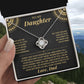 Hand holding the black and gold To My Daughter card from Dad gift box in front of a mountain view