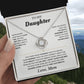 Hand holding the white To My Daughter card from Mom gift box in front of a mountain view