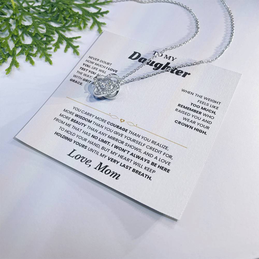 White To My Daughter card from Mom with the Love Knot necklace beside a pine sprig